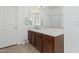 Neutral bathroom featuring a white sink and tile countertop and a dark wood vanity at 10212 W Wier Ave, Tolleson, AZ 85353