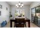 Bright dining room with tile flooring, a chandelier, and a large window with backyard views at 10212 W Wier Ave, Tolleson, AZ 85353