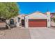 Charming home exterior showcasing desert landscaping and a two-car garage with a beautiful tree at 10212 W Wier Ave, Tolleson, AZ 85353