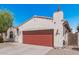 Exterior shot of the garage with red door, showing the house number and adjacent property at 10212 W Wier Ave, Tolleson, AZ 85353