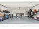 Spacious garage with epoxy flooring and ample storage space at 10212 W Wier Ave, Tolleson, AZ 85353