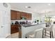 Stylish kitchen featuring dark cabinets, a breakfast bar, stainless steel appliances and ample counter space at 10212 W Wier Ave, Tolleson, AZ 85353