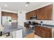 Well-equipped kitchen with stainless steel appliances, dark wood cabinets, and a breakfast bar seating area at 10212 W Wier Ave, Tolleson, AZ 85353