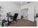 Bright office space featuring an office chair, and easy access to the hallway and bathroom at 10212 W Wier Ave, Tolleson, AZ 85353