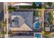 An aerial view of a home showcasing a backyard oasis with pool, putting green, and outdoor seating area at 10455 E Thornton Ave, Mesa, AZ 85212