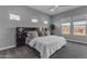 Modern bedroom featuring plush carpet, natural light, a decorative headboard, and neutral colors at 10455 E Thornton Ave, Mesa, AZ 85212