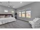 Bright bedroom with plush carpet, lots of natural light, and neutral colors creates a calming retreat at 10455 E Thornton Ave, Mesa, AZ 85212