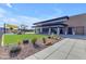 Exterior of the community clubhouse with covered seating areas and landscaping at 10455 E Thornton Ave, Mesa, AZ 85212