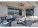 Relaxing covered patio area with comfortable seating and a view of the backyard and well-manicured landscaping at 10455 E Thornton Ave, Mesa, AZ 85212