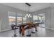 The dining room features natural light and an eye-catching wood table with bar stool seating at 10455 E Thornton Ave, Mesa, AZ 85212