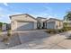 Charming single-story home featuring a three-car garage, desert landscaping, and a neutral-toned stucco exterior at 10455 E Thornton Ave, Mesa, AZ 85212