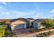 Charming single-story home with a three-car garage, brick paved driveway, and manicured landscaping at 10455 E Thornton Ave, Mesa, AZ 85212