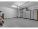 A spacious garage with epoxy flooring and built in storage cabinets, ready for your vehicles and projects at 10455 E Thornton Ave, Mesa, AZ 85212