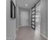 Hallway showcasing a light-filled entry, tiled floors, and a stylish sliding barn door at 10455 E Thornton Ave, Mesa, AZ 85212