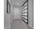 Entryway with ceramic tile flooring, a stylish sliding barn door, and modern accents at 10455 E Thornton Ave, Mesa, AZ 85212