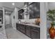 Modern kitchen featuring dark cabinets, granite countertops, stainless steel hood, and sleek appliances at 10455 E Thornton Ave, Mesa, AZ 85212