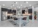 Modern kitchen featuring dark cabinetry, stainless steel appliances, granite countertops, and a large kitchen island at 10455 E Thornton Ave, Mesa, AZ 85212