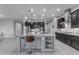 Spacious kitchen island with stainless steel appliances, dark wood cabinets, and modern countertops at 10455 E Thornton Ave, Mesa, AZ 85212