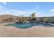 Backyard oasis featuring a sparkling pool, waterfall and desert landscaping at 10455 E Thornton Ave, Mesa, AZ 85212