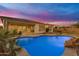 Backyard pool with a rock feature, lush desert landscaping, pool-side patio, string lights and a putting green at 10455 E Thornton Ave, Mesa, AZ 85212