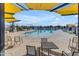 Outdoor community pool with lounge chairs under a shade canopy at 10455 E Thornton Ave, Mesa, AZ 85212