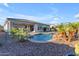 Backyard pool with a rock feature and desert landscaping viewed during the day at 10455 E Thornton Ave, Mesa, AZ 85212