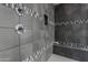 Sleek shower showcasing decorative tile, a built-in bench, and modern fixtures at 10455 E Thornton Ave, Mesa, AZ 85212