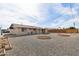 Backyard of the property featuring gravel landscaping, plants, and a covered patio at 10620 W Snead Dr, Sun City, AZ 85351