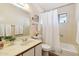 Bathroom featuring a white vanity, toilet, and bathtub with shower curtain at 10620 W Snead Dr, Sun City, AZ 85351