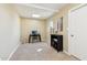 Bedroom with tan carpet, a desk, a black bookcase, and a window at 10620 W Snead Dr, Sun City, AZ 85351