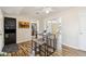 Cozy dining area with wood floors, modern table set, and views into the living room at 10620 W Snead Dr, Sun City, AZ 85351