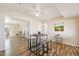 Open dining area with wood floors, a modern table set, and seamless flow to other rooms at 10620 W Snead Dr, Sun City, AZ 85351