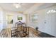 Inviting dining area with wood floors, modern table set, and views of the backyard at 10620 W Snead Dr, Sun City, AZ 85351