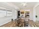 Bright dining area with wood floors, a modern table set, and nearby kitchen access at 10620 W Snead Dr, Sun City, AZ 85351