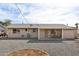 Back of the property with patio and chairs, gravel landscaping, and a clear sky at 10620 W Snead Dr, Sun City, AZ 85351