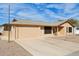 Exterior of a single-story home featuring a garage, driveway, and landscaped front yard at 10620 W Snead Dr, Sun City, AZ 85351