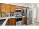 Modern kitchen featuring stainless steel appliances, light countertops, and oak cabinets at 10620 W Snead Dr, Sun City, AZ 85351