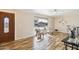 Bright living room featuring wood floors, a large window, and comfortable seating at 10620 W Snead Dr, Sun City, AZ 85351