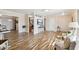 Open-concept living room with wood floors, a wall-mounted TV, and access to the kitchen at 10620 W Snead Dr, Sun City, AZ 85351