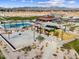 Aerial view showcasing a basketball court, a swimming pool, a playground, and desert landscaping at 116 N 176Th Ln, Goodyear, AZ 85338