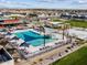 Aerial view captures a community pool with lounge chairs, umbrellas, and desert landscaping at 116 N 176Th Ln, Goodyear, AZ 85338