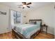 Bedroom with wood floor, ceiling fan, and a view of the backyard at 1165 W 4Th Ave, Apache Junction, AZ 85120