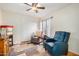 Cozy bedroom featuring a ceiling fan, chair, recliner, and closet with sliding doors at 1165 W 4Th Ave, Apache Junction, AZ 85120