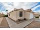 Side exterior view with neutral stucco, desert landscaping, and covered front porch at 1165 W 4Th Ave, Apache Junction, AZ 85120