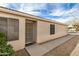 Home exterior features desert landscaping, covered entry with security door, and neutral stucco at 1165 W 4Th Ave, Apache Junction, AZ 85120