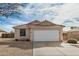 Charming single-story home features a large garage, low-maintenance landscaping, and a tile roof at 1165 W 4Th Ave, Apache Junction, AZ 85120