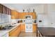 Kitchen boasts white appliances, white countertops, and light wood cabinets at 1165 W 4Th Ave, Apache Junction, AZ 85120