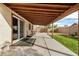 Covered patio providing an outdoor seating area with lush green grass and natural light at 1165 W 4Th Ave, Apache Junction, AZ 85120