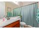 Bathroom featuring a wood vanity, white sink, and a framed mirror at 119 W Leatherwood Ave, San Tan Valley, AZ 85140