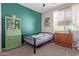 Bedroom with a bed, dresser and green accent wall at 119 W Leatherwood Ave, San Tan Valley, AZ 85140